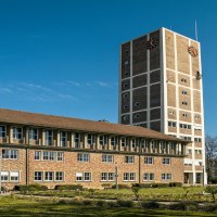 Das Rathaus Kornwestheim mit einem hohen Turm und einem modernen Anbau, umgeben von einem grünen Rasen unter blauem Himmel., © SMG, Sarah Schmid Das Rathaus Kornwestheim mit einem hohen Turm und einem modernen Anbau, umgeben von einem grünen Rasen unter blauem Himmel., © SMG, Sarah Schmid