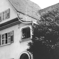 Ein historisches Geb&auml;ude mit einem markanten Dach und Fensterl&auml;den. Ein Baum verdeckt teilweise die Ansicht. Eine Person steht am Fenster., &copy; Stadt N&uuml;rtingen