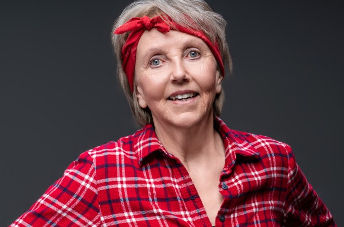 Eine Frau mit rotem Stirnband und kariertem Hemd l&auml;chelt freundlich in die Kamera vor grauem Hintergrund., &copy; Stadt Murrhardt