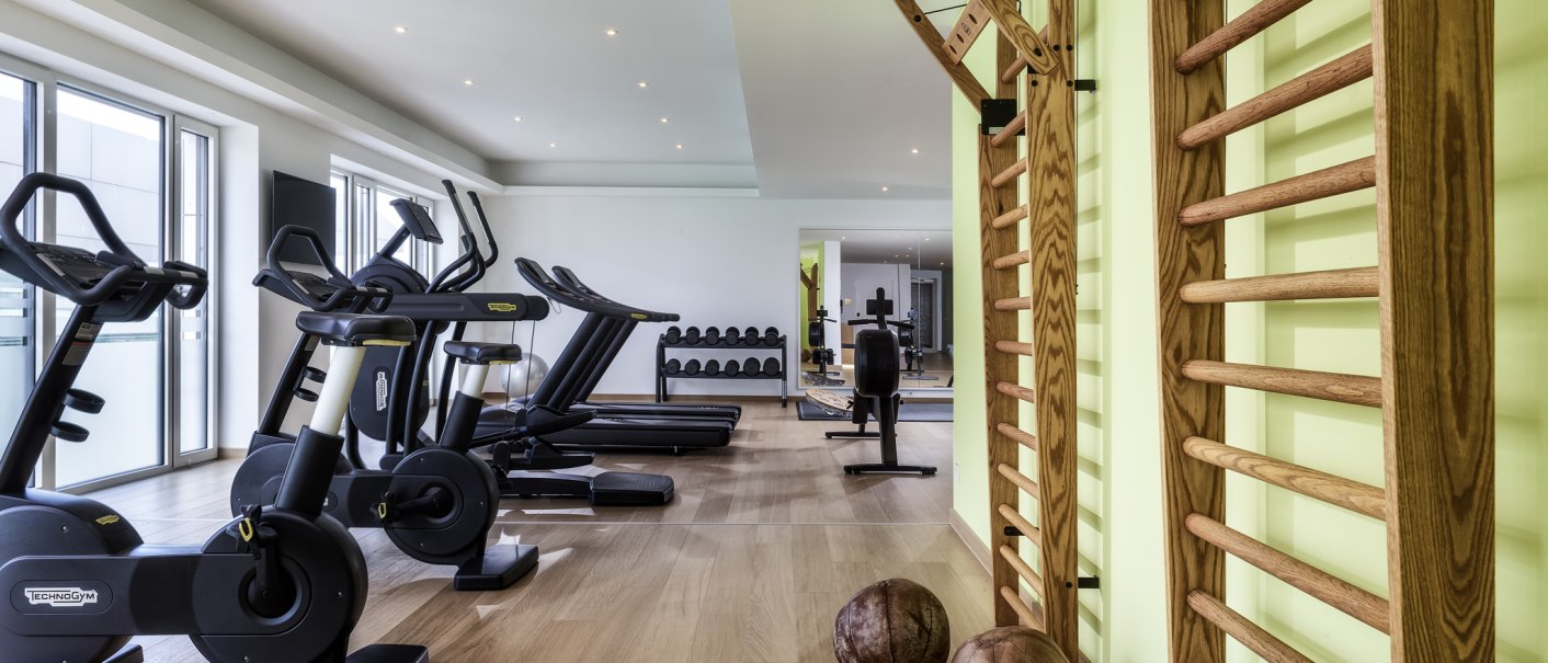 Moderner Fitnessraum mit Laufbändern, Fahrradergometern, Sprossenwand und Medizinbällen auf Holzboden., © Mövenpick Hotel Stuttgart Messe & Congress Moderner Fitnessraum mit Laufbändern, Fahrradergometern, Sprossenwand und Medizinbällen auf Holzboden., © Mövenpick Hotel Stuttgart Messe & Congress