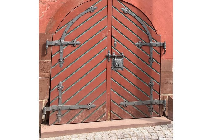 Rote Holzt&uuml;r mit diagonalen Streifen und schweren Metallbeschl&auml;gen in einem gemauerten Bogen., &copy; Stadtverwaltung Weil der Stadt