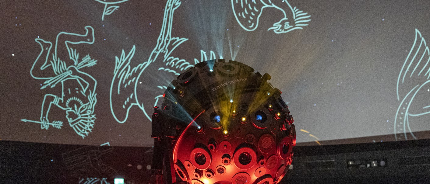 Ein Projektor im Planetarium projiziert Sternbilder an die Decke. Der Raum ist dunkel, mit leuchtenden Linien und Figuren., © Stuttgart-Marketing GmbH, Sarah Schmid