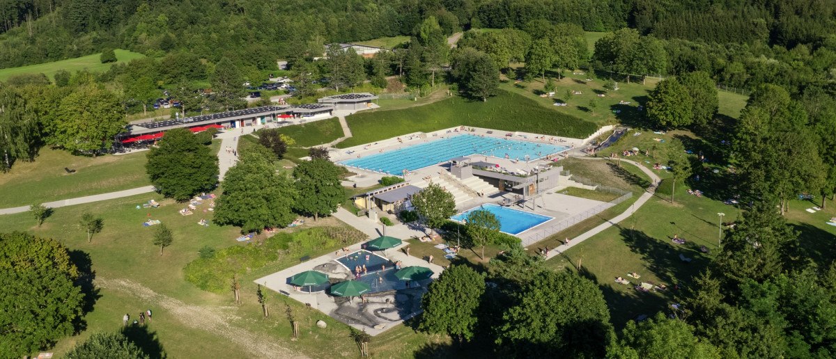 mehrere Schwimmbecken inmitten großzügiger, baumbestandener Liegewiese, © Stadt Gaildorf