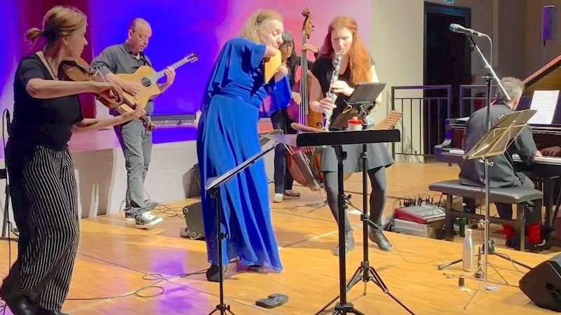 Musiker auf einer Bühne spielen Klezmer-Musik mit Panflöte, Gitarre und Klarinette. Lebendige Atmosphäre mit buntem Licht., © Konzertbüro Hannah Schlubeck Musiker auf einer Bühne spielen Klezmer-Musik mit Panflöte, Gitarre und Klarinette. Lebendige Atmosphäre mit buntem Licht., © Konzertbüro Hannah Schlubeck