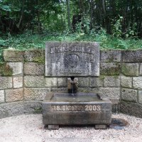 Steinerner Jakobsbrunnen im Wald, mit Inschrift 'Quo Vadis?' und Datum 18. Oktober 2003. Umgeben von gr&uuml;ner Vegetation., &copy; N&uuml;rtingen - Stuttgart-Marketing GmbH