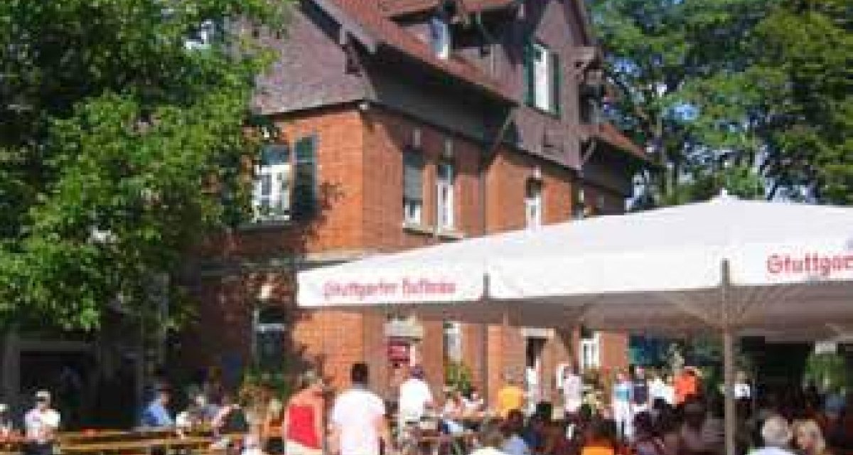 Menschen sitzen in einem Biergarten mit Sonnenschirmen vor einem Backsteingebäude. Fahrräder sind im Vordergrund zu sehen., © Sindelfingen - Stuttgart-Marketing GmbH