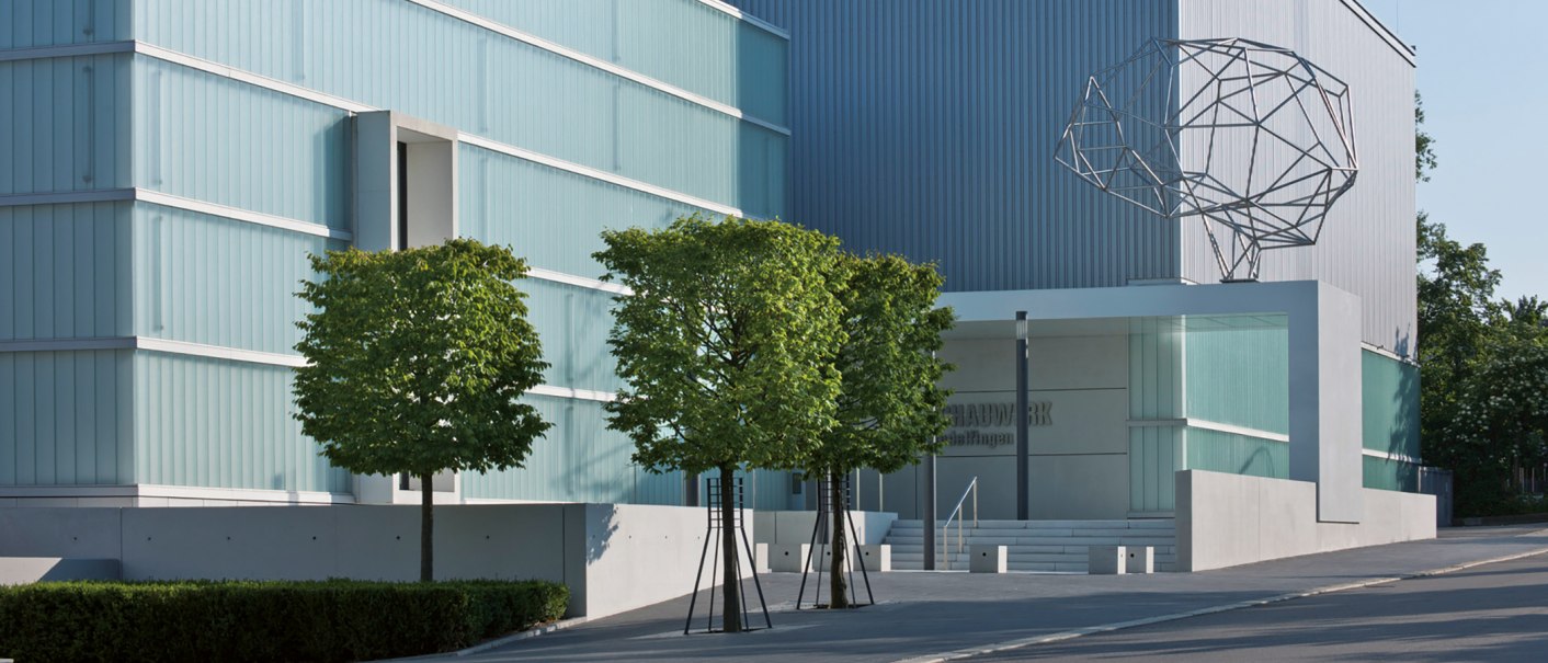 Moderne Architektur des Schauwerks Sindelfingen mit Glasfassade, Bäumen und einer abstrakten Skulptur auf dem Dach., © Stuttgart-Marketing GmbH