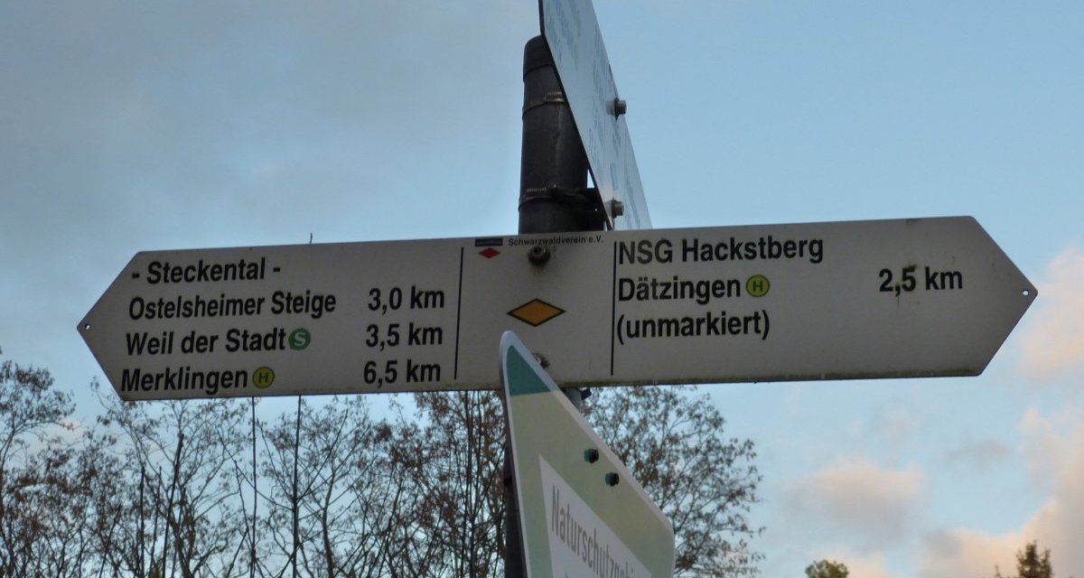 Ein Wegweiser im Naturschutzgebiet Steckental zeigt Entfernungen zu nahegelegenen Orten wie Ostelsheimer Steige und Weil der Stadt., © Natur.Nah. Schönbuch & Heckengäu Ein Wegweiser im Naturschutzgebiet Steckental zeigt Entfernungen zu nahegelegenen Orten wie Ostelsheimer Steige und Weil der Stadt., © Natur.Nah. Schönbuch & Heckengäu