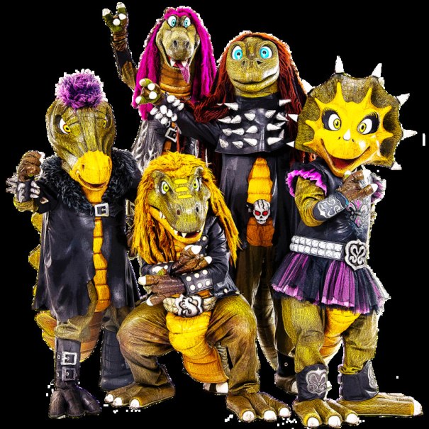 Fünf Dinosaurier in bunten Rocker-Outfits posieren fröhlich. Sie tragen Lederjacken, Nieten und bunte Perücken., © Scala Kultur Live gGmbH