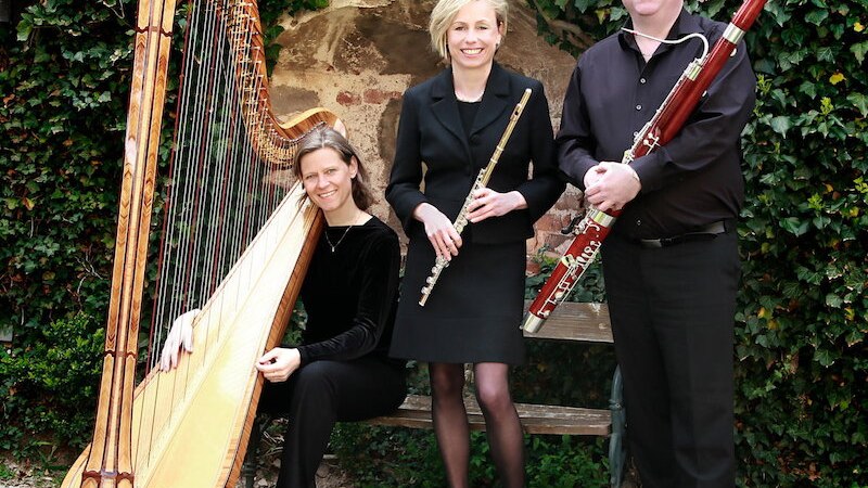 Drei Musiker posieren mit Harfe, Flöte und Fagott vor einer efeubewachsenen Mauer. Sie tragen elegante schwarze Kleidung., © Kulturfenster Bönnigheim e. V. Drei Musiker posieren mit Harfe, Flöte und Fagott vor einer efeubewachsenen Mauer. Sie tragen elegante schwarze Kleidung., © Kulturfenster Bönnigheim e. V.