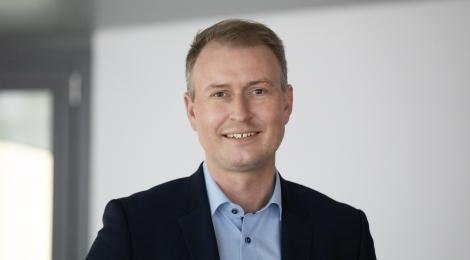 Ein Mann in einem dunklen Anzug und hellblauem Hemd lächelt in die Kamera. Der Hintergrund ist neutral und hell., © Stadt Esslingen am Neckar Ein Mann in einem dunklen Anzug und hellblauem Hemd lächelt in die Kamera. Der Hintergrund ist neutral und hell., © Stadt Esslingen am Neckar