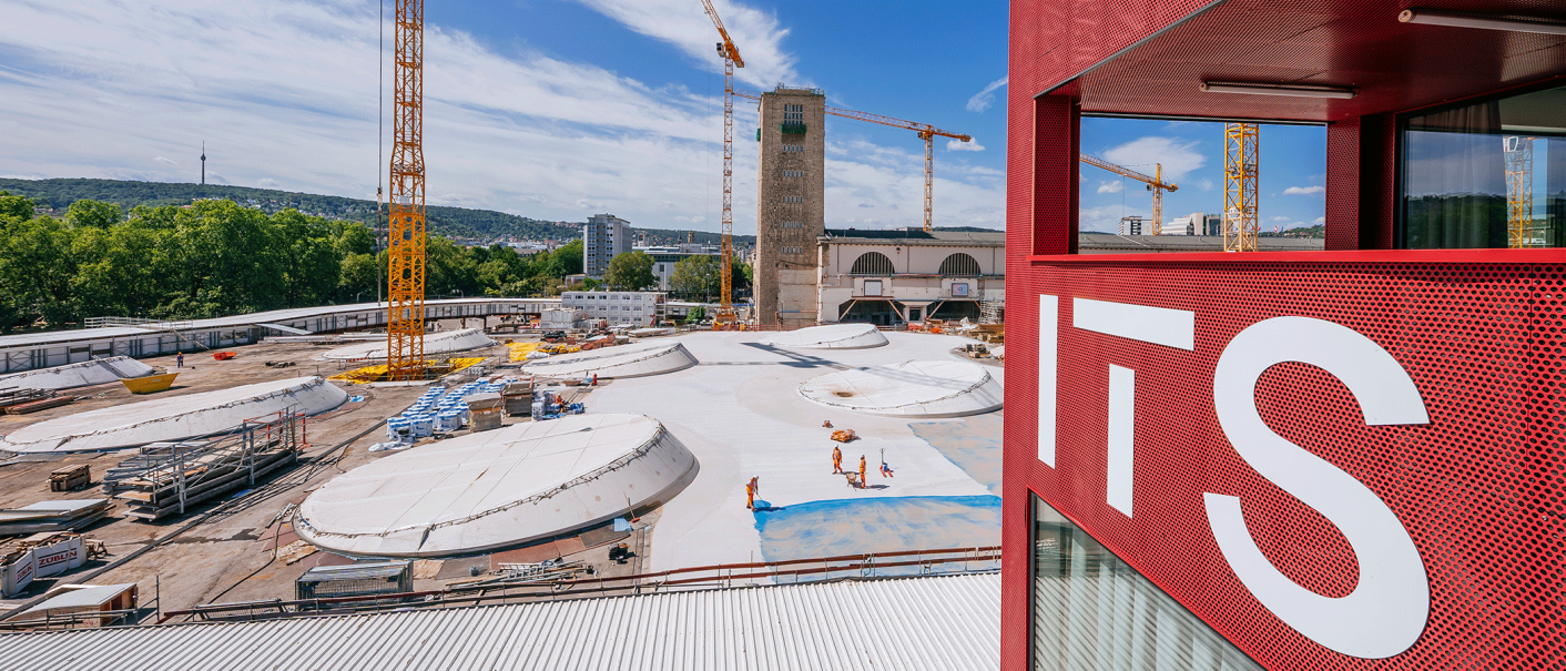 Blick auf eine Baustelle mit mehreren Kränen und einem roten Gebäude mit der Aufschrift 'ITS' im Vordergrund., © Thomas Niedermüller