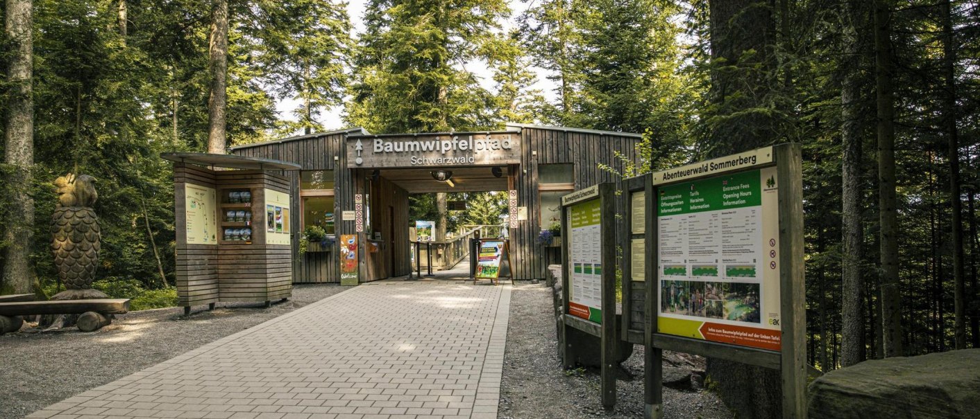Eingang zum Baumwipfelpfad im Schwarzwald, umgeben von Bäumen. Infotafeln und eine Holzskulptur sind sichtbar., © Stuttgart-Marketing GmbH, Sarah Schmid Eingang zum Baumwipfelpfad im Schwarzwald, umgeben von Bäumen. Infotafeln und eine Holzskulptur sind sichtbar., © Stuttgart-Marketing GmbH, Sarah Schmid
