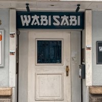 Außenansicht der Wabisabi Bar mit Eingangstür, Schildern und der Hausnummer 43. Die Bar bietet Drinks, Musik und Cup Noodles an., © SMG Außenansicht der Wabisabi Bar mit Eingangstür, Schildern und der Hausnummer 43. Die Bar bietet Drinks, Musik und Cup Noodles an., © SMG