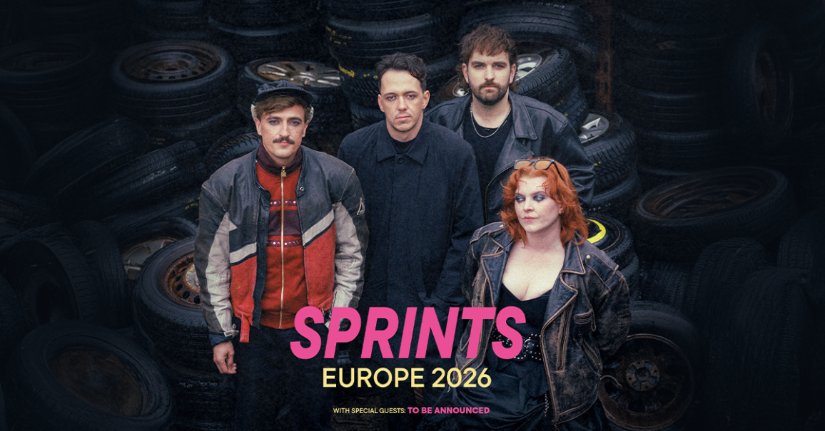 Die Band SPRINTS steht vor einem Stapel alter Reifen. Ank&uuml;ndigung ihrer Europa-Tour 2026 mit noch nicht bekanntgegebenen G&auml;sten., &copy; links im Bild