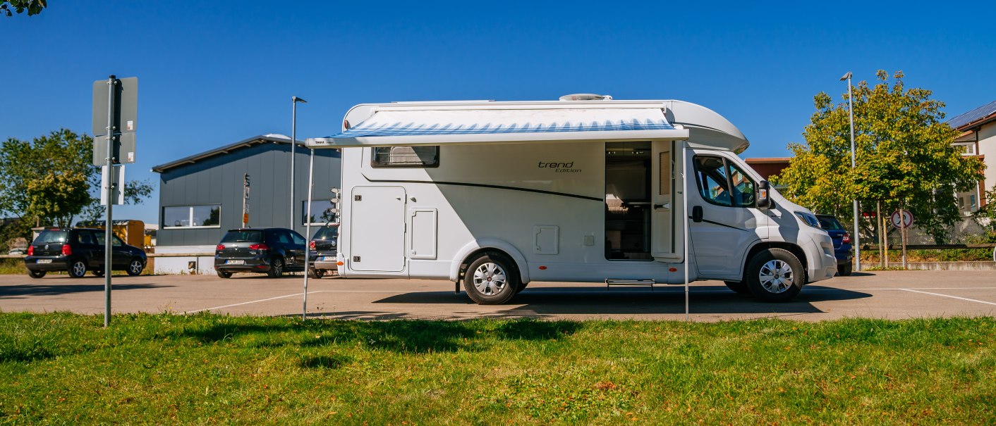 Ein Wohnmobil steht auf einem Parkplatz bei sonnigem Wetter. Im Hintergrund sind Autos und ein Gebäude zu sehen., © Stuttgart-Marketing GmbH, Thomas Niedermüller