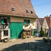 Ein idyllischer Innenhof in Nürtingens Altstadt mit Fachwerkhaus, grünen Fensterläden und gemütlichen Sitzgelegenheiten unter einem Baum., © Stuttgart-Marketing GmbH, Sarah Schmid Ein idyllischer Innenhof in Nürtingens Altstadt mit Fachwerkhaus, grünen Fensterläden und gemütlichen Sitzgelegenheiten unter einem Baum., © Stuttgart-Marketing GmbH, Sarah Schmid