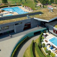 Luftaufnahme des Fildorado mit begrüntem Dach, Außenpool und Liegewiese. Menschen entspannen und schwimmen bei sonnigem Wetter., © Sport- und Badezentrum Fildorado GmbH Luftaufnahme des Fildorado mit begrüntem Dach, Außenpool und Liegewiese. Menschen entspannen und schwimmen bei sonnigem Wetter., © Sport- und Badezentrum Fildorado GmbH