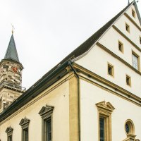 Die Stadtkirche G&ouml;ppingen mit ihrem markanten Turm und Giebeldach vor bew&ouml;lktem Himmel und herbstlichen B&auml;umen., &copy; Stuttgart-Marketing GmbH, Sarah Schmid