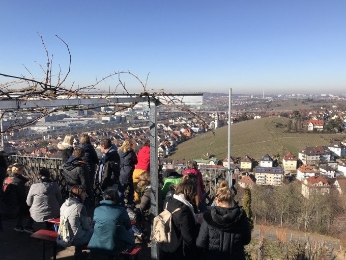 Menschen genie&szlig;en auf einer Terrasse den Ausblick auf Stuttgart und die umliegenden Weinberge bei sonnigem Wetter., &copy; Weingenuss Stuttgart