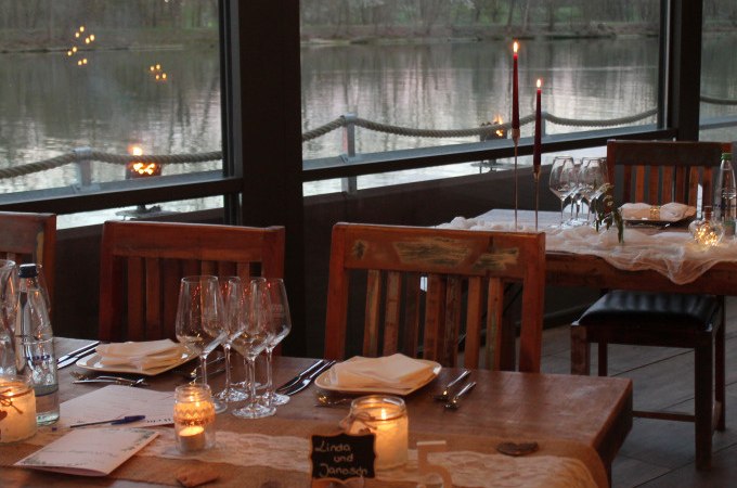 Ein romantisch gedeckter Tisch in einem Restaurant mit Kerzenlicht und Blick auf einen See. Der Tisch ist für ein Blind-Date Dinner vorbereitet., © Cool-Tours StattReisen Ein romantisch gedeckter Tisch in einem Restaurant mit Kerzenlicht und Blick auf einen See. Der Tisch ist für ein Blind-Date Dinner vorbereitet., © Cool-Tours StattReisen