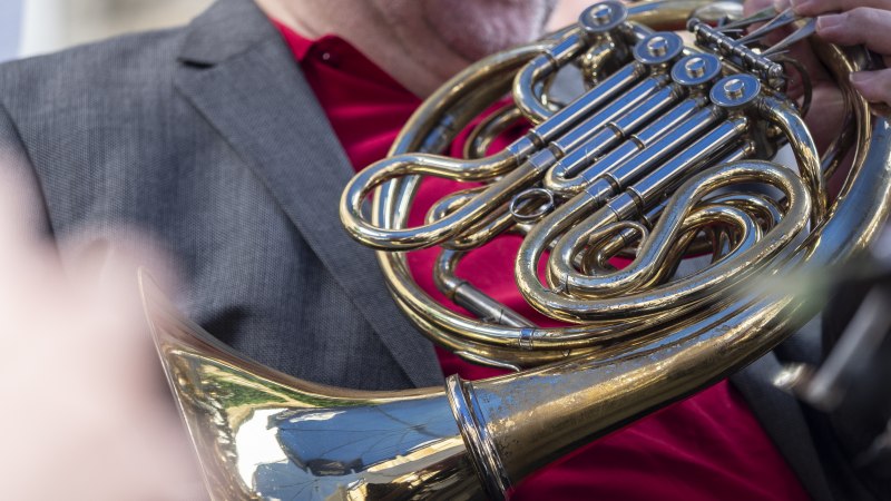 Ein Musiker in rotem Hemd und grauem Sakko spielt ein gl&auml;nzendes Horn. Die Ventile und das Mundst&uuml;ck sind deutlich sichtbar., &copy; Torsten Wenzler