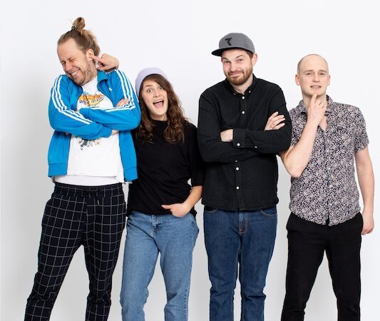 Vier Personen stehen lächelnd vor einem weißen Hintergrund. Sie tragen lässige Kleidung und wirken entspannt und fröhlich., © Interessengemeinschaft Kultur Sindelfingen / Böblingen e.V.