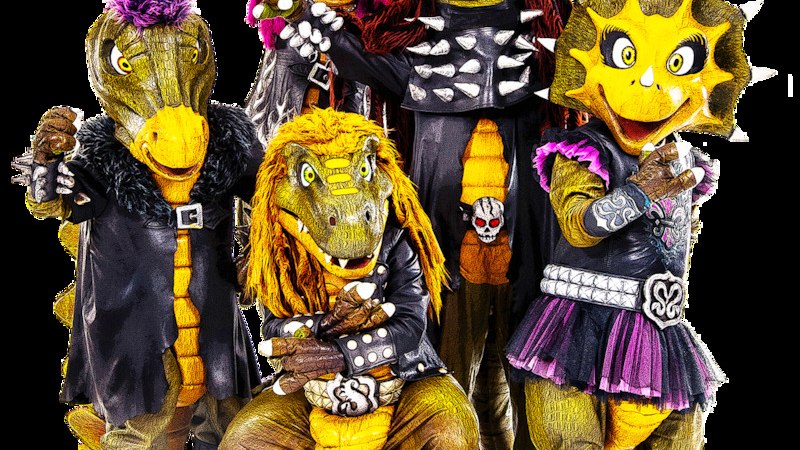 F&uuml;nf Dinosaurier in bunten Rocker-Outfits posieren fr&ouml;hlich. Sie tragen Lederjacken, Nieten und bunte Per&uuml;cken., &copy; Scala Kultur Live gGmbH