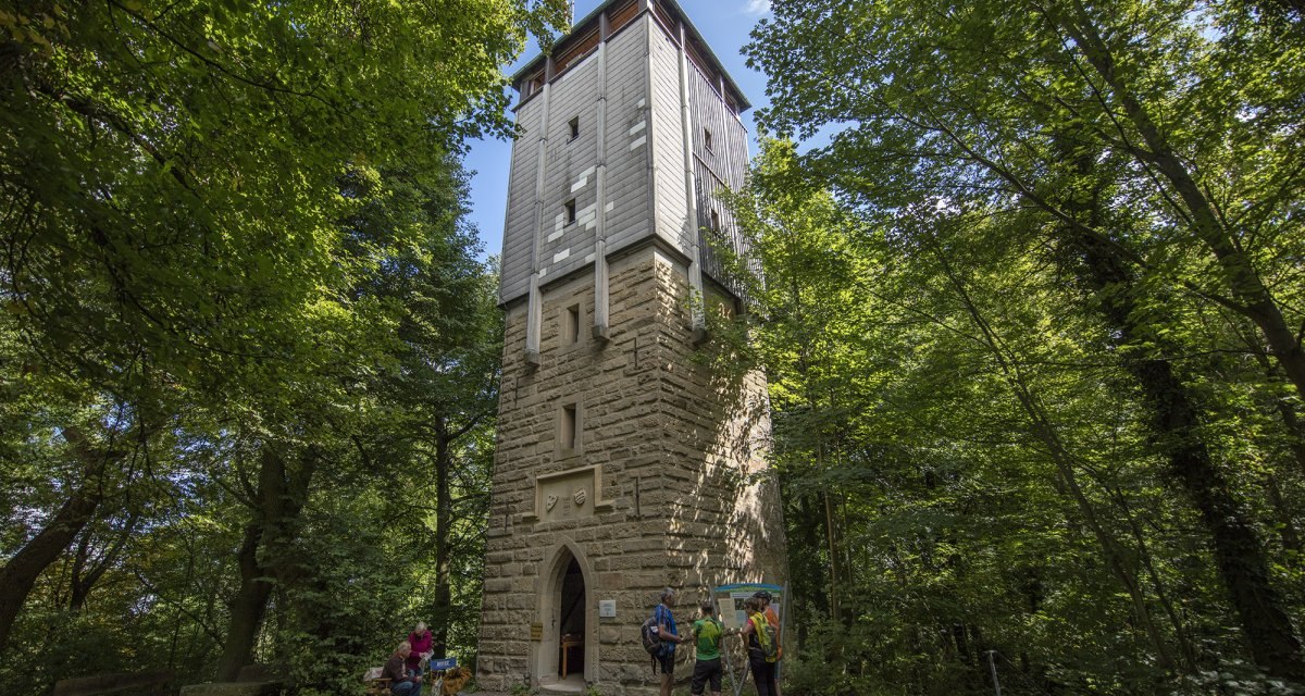Der Wunnensteinturm steht im Wald, umgeben von Bäumen. Vor dem Turm sind mehrere Personen zu sehen, die den Turm betrachten., © Stuttgart Marketing GmbH Der Wunnensteinturm steht im Wald, umgeben von Bäumen. Vor dem Turm sind mehrere Personen zu sehen, die den Turm betrachten., © Stuttgart Marketing GmbH