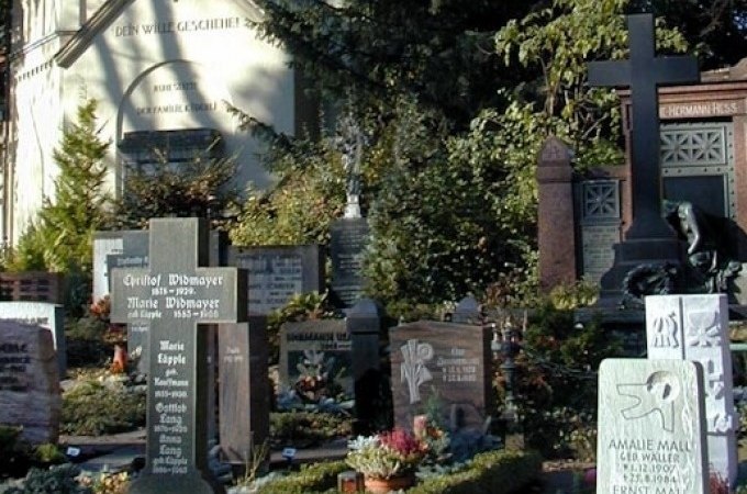 Ein Friedhof mit mehreren Grabsteinen, umgeben von Pflanzen und Bäumen. Im Hintergrund ist eine Kapelle zu sehen., © WTM GmbH Waiblingen