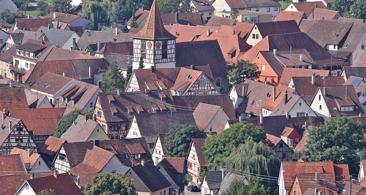 Luftaufnahme von Ensingen zeigt Fachwerkhäuser und einen markanten Kirchturm inmitten der Dächerlandschaft., © Land der 1000 Hügel - Kraichgau-Stromberg Luftaufnahme von Ensingen zeigt Fachwerkhäuser und einen markanten Kirchturm inmitten der Dächerlandschaft., © Land der 1000 Hügel - Kraichgau-Stromberg