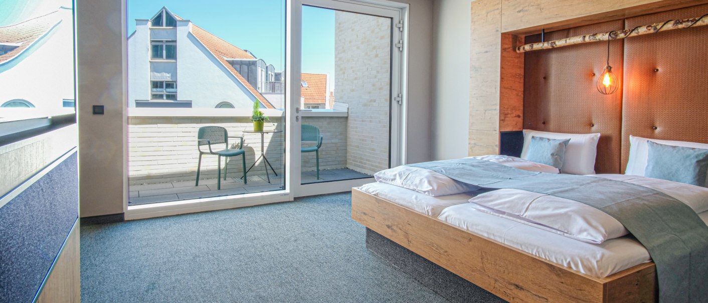 Modernes Hotelzimmer mit Doppelbett, stilvoller Beleuchtung und Zugang zu einer Terrasse mit zwei Stühlen und Tisch., © 13 6 Design GmbH (Judenhof 10, 89073 Ulm) Modernes Hotelzimmer mit Doppelbett, stilvoller Beleuchtung und Zugang zu einer Terrasse mit zwei Stühlen und Tisch., © 13 6 Design GmbH (Judenhof 10, 89073 Ulm)