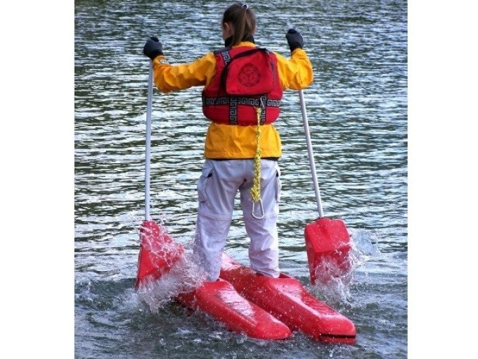 Person in gelber Jacke und roter Weste steht auf schwimmenden Geräten im Wasser und hält zwei Paddel., © Cool-Tours StattReisen Person in gelber Jacke und roter Weste steht auf schwimmenden Geräten im Wasser und hält zwei Paddel., © Cool-Tours StattReisen