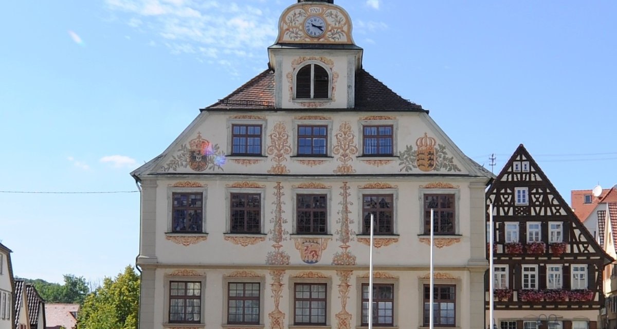 Historisches Rathaus mit verziertem Giebel und Uhrturm, davor ein Brunnen auf einem gepflasterten Platz., © Land der 1000 Hügel - Kraichgau-Stromberg Historisches Rathaus mit verziertem Giebel und Uhrturm, davor ein Brunnen auf einem gepflasterten Platz., © Land der 1000 Hügel - Kraichgau-Stromberg