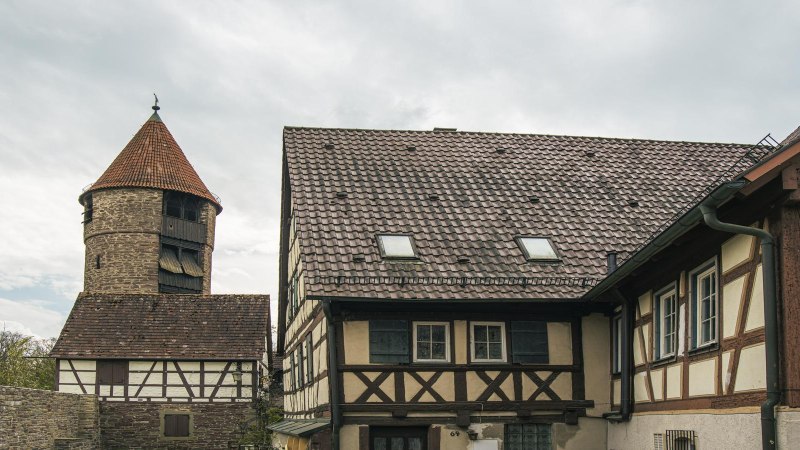Der Seilerturm in Weil der Stadt neben Fachwerkhäusern, unter bewölktem Himmel. Historische Architektur in einer malerischen Umgebung., © SMG,  Sarah Schmid