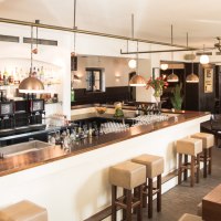 Stilvolles Restaurant mit Bar, Holzmöbeln und gedeckten Tischen. Helle Beleuchtung und gemütliche Atmosphäre., © Amadeus, Stuttgart