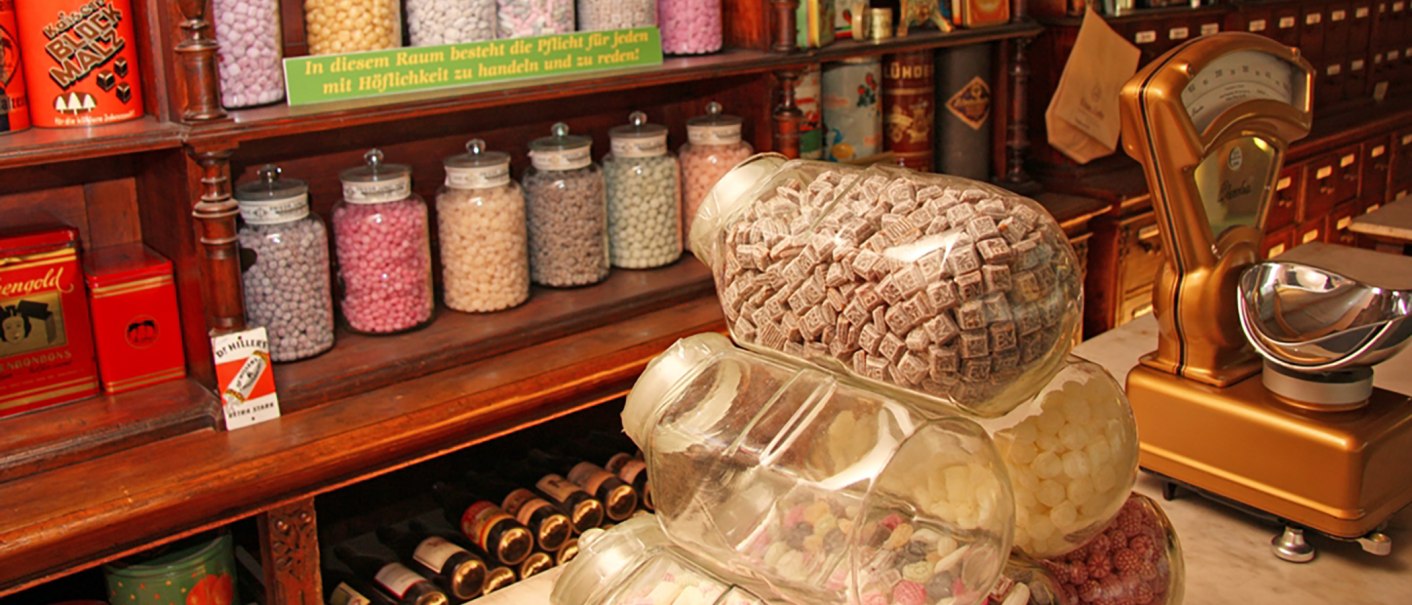 Ein nostalgischer Bonbonladen mit großen Gläsern voller bunter Süßigkeiten und einer antiken Waage auf einem Holztresen., © Stadt Vaihingen an der Enz Ein nostalgischer Bonbonladen mit großen Gläsern voller bunter Süßigkeiten und einer antiken Waage auf einem Holztresen., © Stadt Vaihingen an der Enz