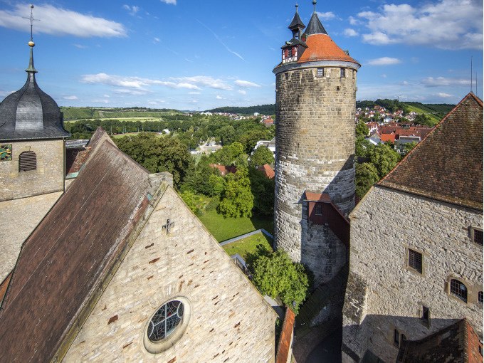 Historische Gebäude und ein Turm in Besigheim, umgeben von grüner Landschaft und blauem Himmel., © Stadt Besigheim Historische Gebäude und ein Turm in Besigheim, umgeben von grüner Landschaft und blauem Himmel., © Stadt Besigheim