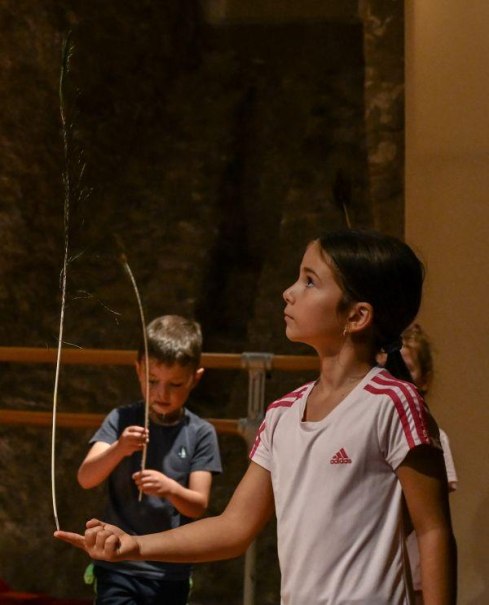 Kinder balancieren Federn auf den Fingern in einem Workshop. Ein Mädchen im Vordergrund konzentriert sich, während ein Junge im Hintergrund ebenfalls übt., © Kunstschule Labyrinth Kinder balancieren Federn auf den Fingern in einem Workshop. Ein Mädchen im Vordergrund konzentriert sich, während ein Junge im Hintergrund ebenfalls übt., © Kunstschule Labyrinth